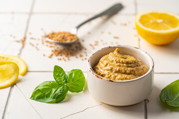 Poster - Fresh homemade organic dijon mustard in a bowl on white background, close up