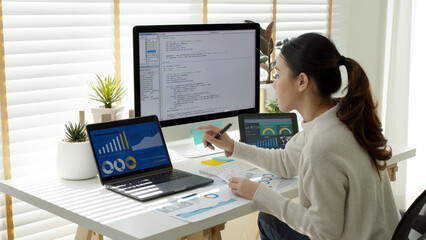 asia young business woman sit busy at home office desk work code on desktop pc reskill upskill for j