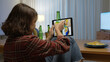 © ChayTee - Young happy attractive asia female enjoy relax night party event online celebration festive with friends at home sofa pr table clinking beer with glass and bottle drinking via online videocall.