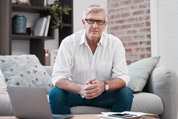 Poster - No need to recognise the road ahead. Portrait of an older man using his laptop while sitting on the couch at home.