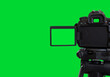 canvas print picture - Dslr camera with empty screen on the tripod, isolated on green background. Green screen camera.