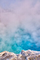 Turquoise hot pool with steam in Yellowstone