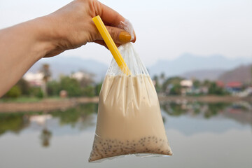 Hot fresh homemade soy milk in a plastic bag selling by street vendors in Thailand. Usually can add boiled red beans, tapioca, boiled job’s tears, basil seeds, various transparent jellies.