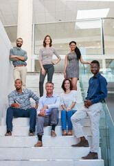 Poster - Were the best team in the business. Full length portrait of a group of businesspeople on the stairs of their office.