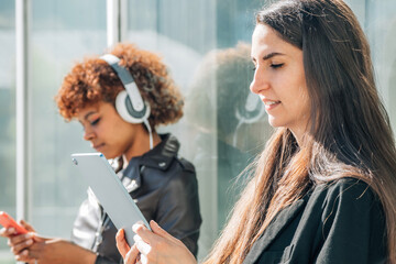 girl in the street with portable device or tablet