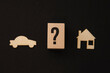 Wooden symbols, blocks on the black background car question mark house
