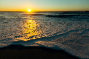 Wall Mural - Amazing sunset on the Atlantic coast with foamy surf.