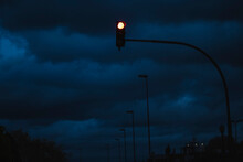 A Traffic Light On The Road At Night.