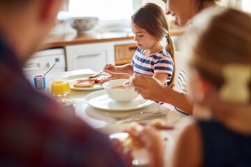 having fun at the breakfast table. shot of a family having breakfast together.