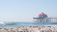 Retro Huntington Pier, Surfing In Ocean Waves And Sandy Beach, California Coast Near Los Angeles, USA. American Diner, Sea Water, Beachfront Boardwalk, Summer Vacations. Seamless Looped Cinemagraph.