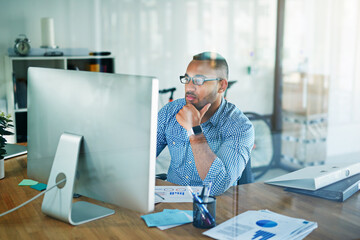 Aufkleber - You can always find him at his desk. Cropped shot of a handsome young businessman working in his office.