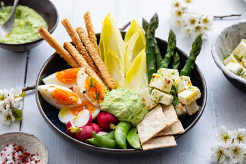 Wall Mural - Easter sharing platter with eggs, asparagus, crunchy vegetables and feta