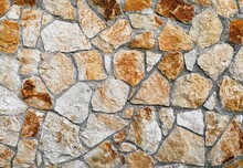 Textured Stone Wall Background. Yellow And Orange Rock Wall