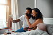 © Jadon B/peopleimages.com - Start the day with food, love and laughter. Cropped shot a young attractive couple taking a selfie while having breakfast in bed at home.