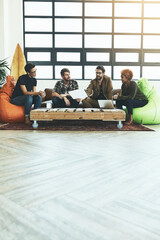 Poster - Keep an open mind when exploring new possibilities. Shot of a group of young designers discussing paperwork.