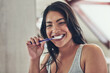 © Nola V/peopleimages.com - Fresh breath to start off a new day. Portrait of an attractive young woman brushing her teeth at home.