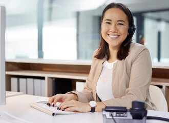 Canvas Print - You have my undivided attention. Portrait of a young woman using a headset and computer in a modern office.