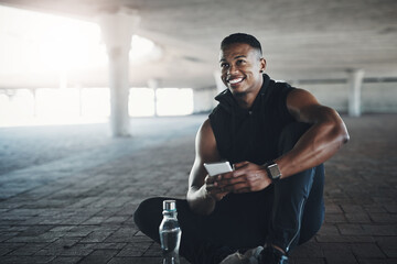Fototapete - Post workout endorphins. Cropped shot of a handsome young man sending a text while exercising outside.