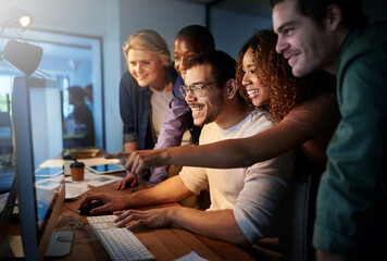 Aufkleber - Their new website looks amazing. Shot of a team of young businesspeople working late in the office.