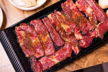 Premium frozen raw pork on plate, Korean traditional style fresh pork beef belly BBQ, Japanese meat hot pot or Shabu in the restaurant, barbecue food