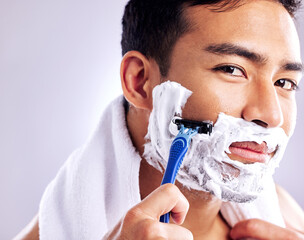 Wall Mural - Its time to get that baby face back. Cropped shot of a handsome young man shaving his facial hair.