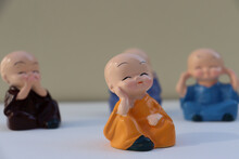 Selective Focus On Laughing Buddha With Isolate Background. Cute Little Colorful Laughing Buddha. Small Colorful Toys