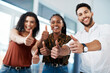 © Chanelle M/peopleimages.com - Thumbs up to opportunities. Cropped portrait of a diverse group of business colleagues standing together in the office and showing a thumbs up.