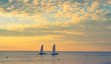 Two Catamarans In Sunset Sea