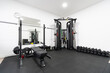 © Westend61 - Exercise equipment and dumbbells in empty gym