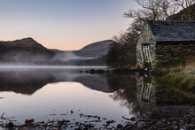 UK, Wales, Lakeshore Hut At Foggy Dawn