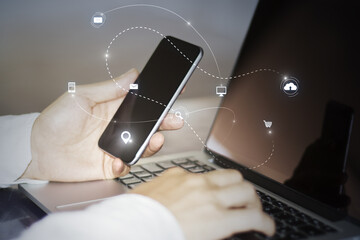 Aufkleber - Close up of hand using laptop keyboard and phone with abstract SEO search and communication hologram on blurry background. Double exposure.