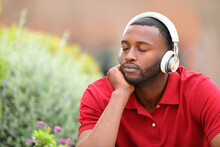 Man With Black Skin Resting Listening To Music