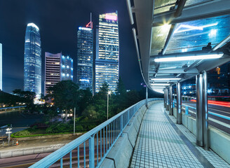 pedestrian walkway and skyscraper in Hong Kong city at night