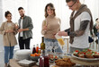 © New Africa - Group of people enjoying brunch buffet together indoors