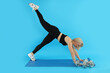 © Atlas - Concept of healthy lifestyle with sporty woman on blue background