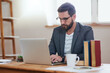 © AS/peopleimages.com - Hes always hard at work. Cropped shot of a handsome young businessman working on his laptop while sitting in the home office.