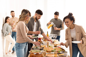 Group of people enjoying brunch buffet together indoors