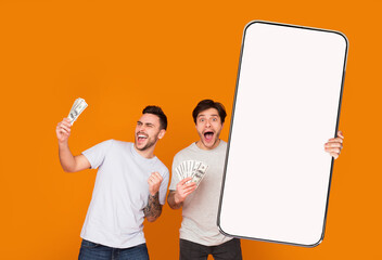 Poster - Two young guys gambling online, holding smartphone and cash