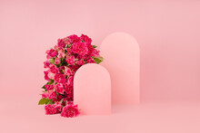 Fresh Pink Roses As Arch, Empty Rounded Doors As Two Podiums On Abstract Pink Scene Mockup For Presentation Cosmetic Products Or Goods, Copy Space. Romantic Summer Template For Advertising, Design.