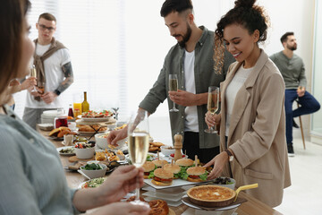 Wall Mural - Group of people enjoying brunch buffet together indoors