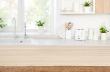 Wall Mural - wood table top on blur modern kitchen room counter background