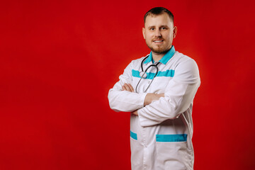 Portrait of a doctor, young  doctor man wearing stethoscope standing over isolated red background . 
portrait of a smiling doctor.