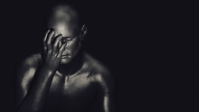 A Male Figure With One Hand Covering His Face And An Expression Of Anguish On A Dark Background. 3d Illustration.