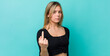 young pretty blonde woman feeling angry, annoyed, rebellious and aggressive, flipping the middle finger, fighting back