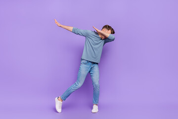 Wall Mural - Photo of funny adorable guy wear grey shirt having fun dancing showing dab isolated violet color background