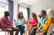 © WavebreakMediaMicro - Caucasian senior woman discussing with multiracial people during group therapy session