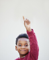 Put a smile on a childs face by showing your support. Shot of an adorable little boy standing against a white background.