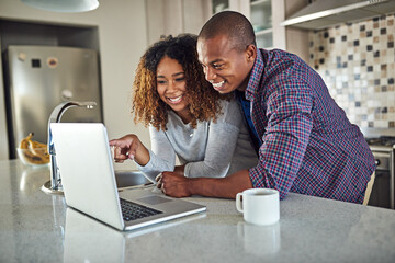 Have you seen this. Cropped shot of an affectionate young couple using a laptop in their kitchen at home.