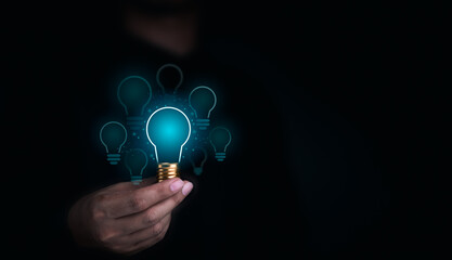 Poster - Creative idea management, solution, innovation, knowledge technology, and inspiration concept. Glowing blue light bulbs graphics with blank space inside in human hand on dark background.