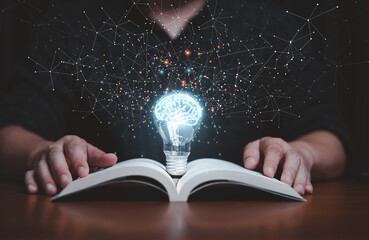 Wall Mural - Glowing lightbulb with virtual brain on open book and connection line for reading and education make smart or creative thinking idea concept.